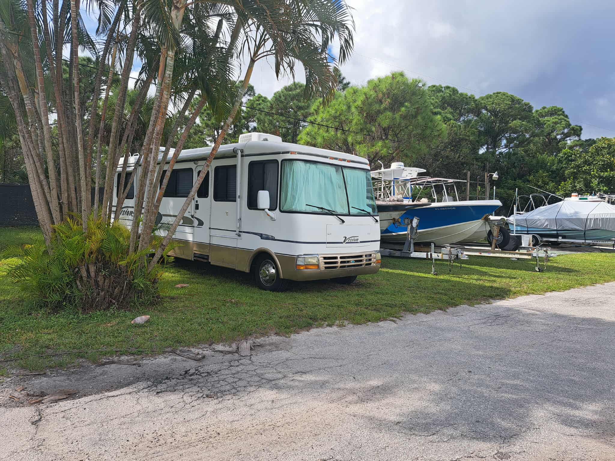 RV lot with boat storage and palm trees